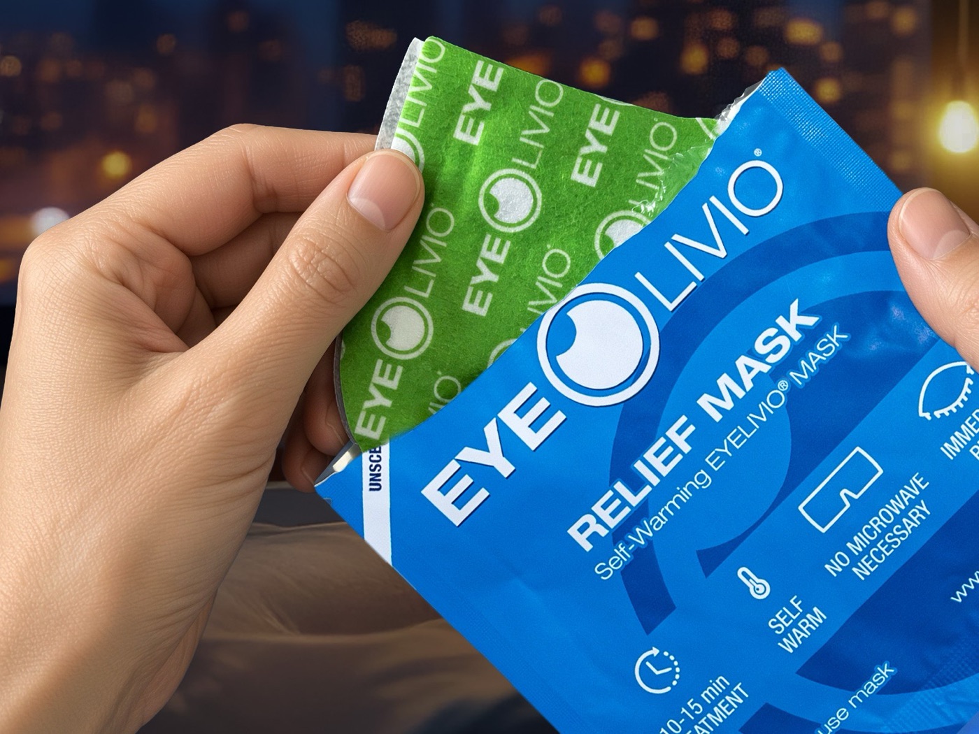 Hands opening an EYELIVIO self-warming mask pouch